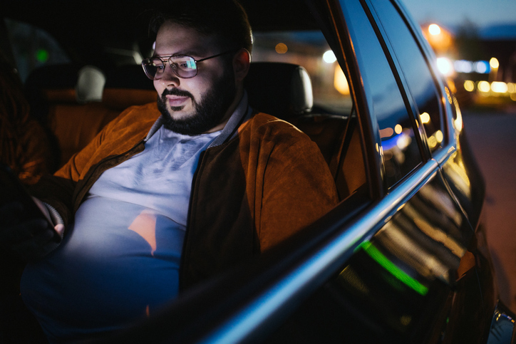 Man driving in a car and text messaging