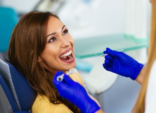 Happy patient at the dentist - stock photo