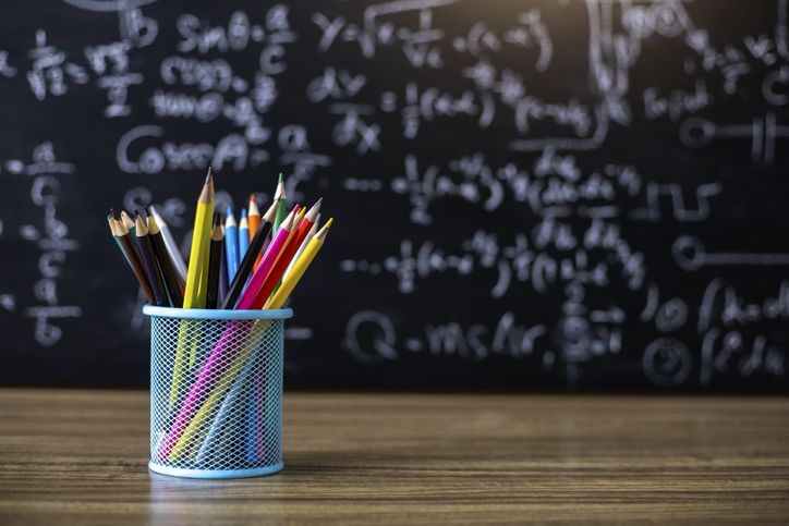 Colored pencils on the blackboard background