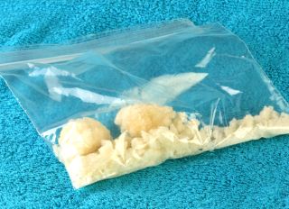 Bag of illegal drugs on a blue background
