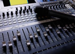 Microphone, Amplifying Equipment, Studio Audio Mixer Knobs And Faders. Workplace And Equipment Of The Sound Engineer. Acoustic Mixing Of Music, Selective Focus.