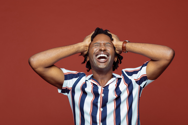 Happy young man in retro style striped shirt