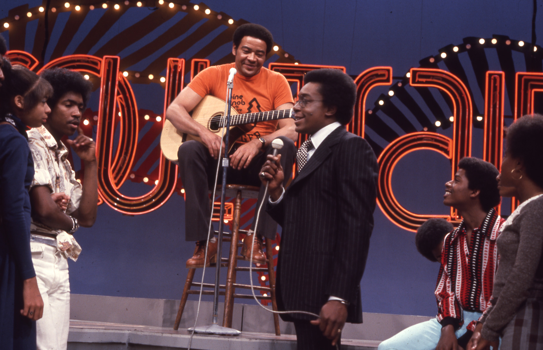 Don Cornelius takes questions for Bill Withers from the dancers on Soul Train.