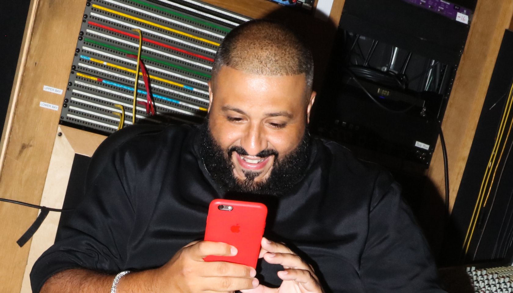 DJ Khaled posting a snapchat video with his phone at a private listening party for DJ Khaled's album Major Key, at Premiere Recording Studios