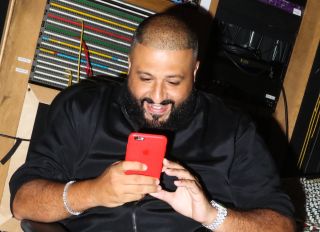 DJ Khaled posting a snapchat video with his phone at a private listening party for DJ Khaled's album Major Key, at Premiere Recording Studios
