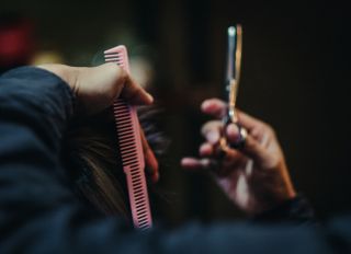 Hairdresser Cutting Customer Hair In Salon
