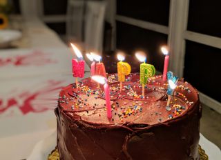 Close-Up Of Lit Candles On Birthday Cake