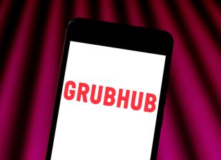 In this photo illustration a Grubhub logo seen displayed on...