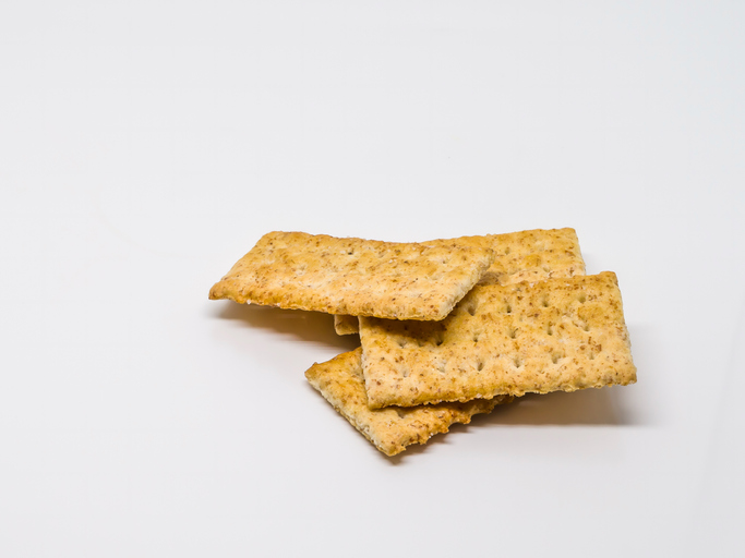 Close-Up Of Snack Crackers Against White Background