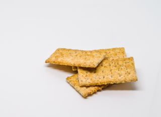 Close-Up Of Snack Crackers Against White Background