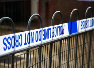 Police tape on a fence at a crime scene cordon in London...