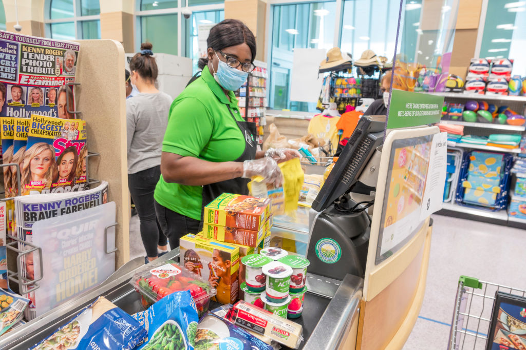 Miami Beach, Publix grocery store, cashier wearing face mask, gloves and new plexiglass shield protection