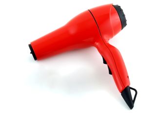 Red hairdryer on a white background