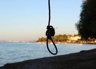 Close-Up Of Silhouette Rope On Beach Against Clear Sky
