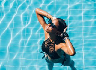 Young Black woman at resort pool