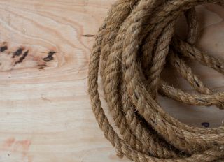 Top view shot of Hemp rope on the wooden background floor