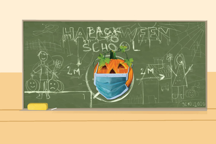Drawing of a Halloween pumpkin with a face mask on the blackboard