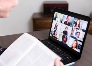 Unrecognizable woman uses video conferencing for book club