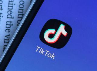 In this photo illustration a TikTok logo is seen displayed...