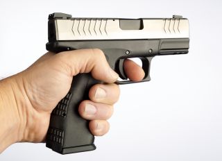 Stock image of finger on the trigger of a gun