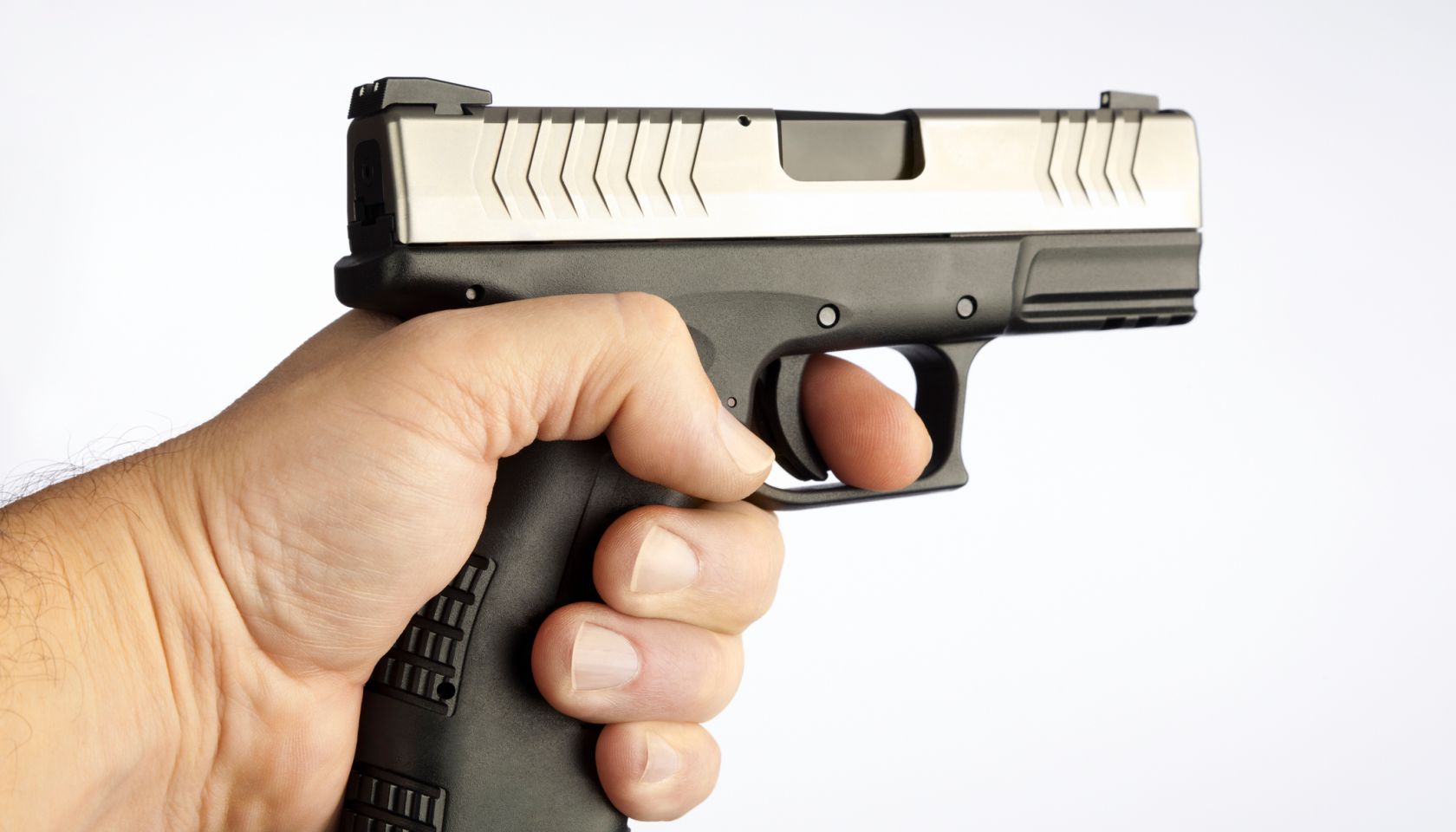 Stock image of finger on the trigger of a gun