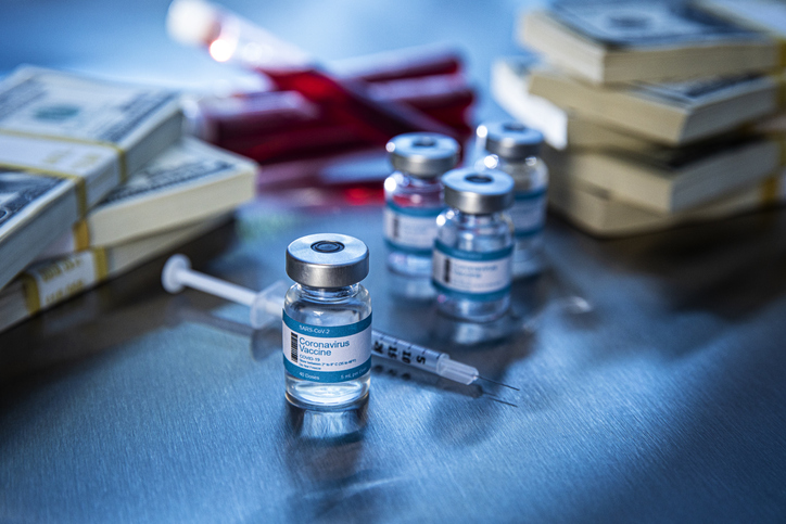 Coronavirus vaccine vials in hospital with money