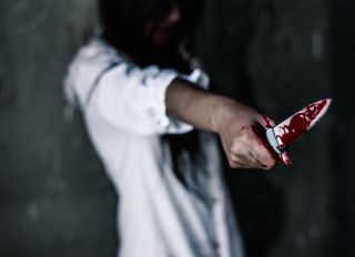 Woman Holding Blood Stain Knife