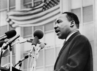 Martin Luther King, Jr., half-length portrait, facing left, speaking at microphones, during anti-war demonstration, New York City, New York, USA, Don Rice for World Journal Tribune, 1967