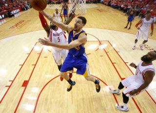 Golden State Warriors' Klay Thompson (11) takes a shot against Houston Rockets' Josh Smith (5) in the second half of Game 4 of the NBA Western Conference finals at the Toyota Center in Houston, Texas, on Monday, May 25, 2015. (Nhat V. Meyer/Bay Area News