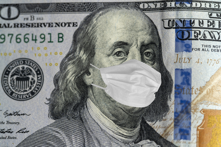 100 dollar banknote with medical mask. World financial crisis concept