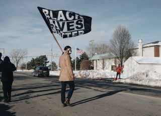Man Holds Black Lives Matter Flag