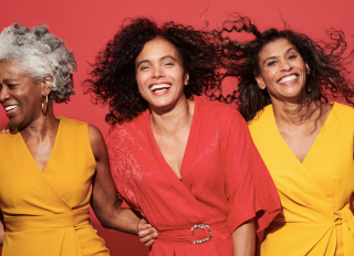 Portrait of a group of mature women against a red background - stock photo