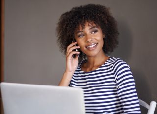 Black woman taking business call