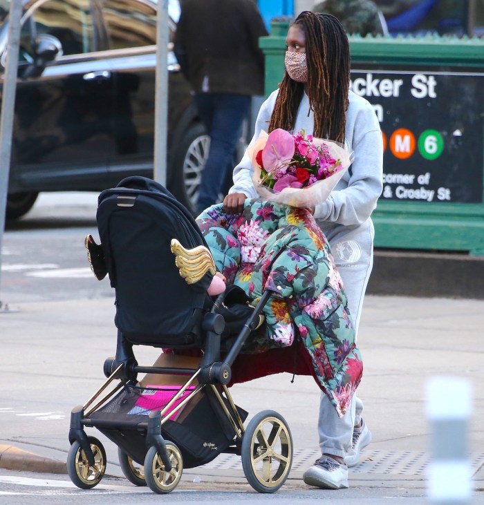Jodie Turner-Smith walking daughter Janie Jackson in a stroller in Soho