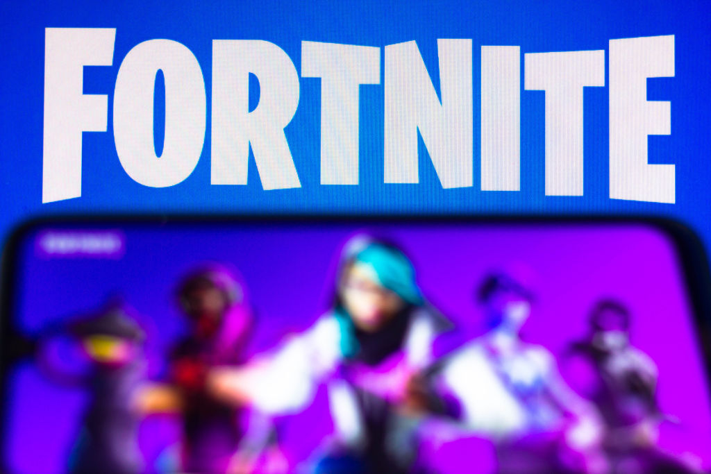In this photo illustration the Fortnite logo is seen on a...