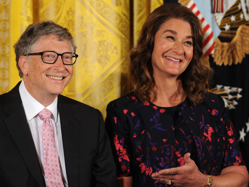 Bill and Melinda Gates react as former U.S. President Barack...