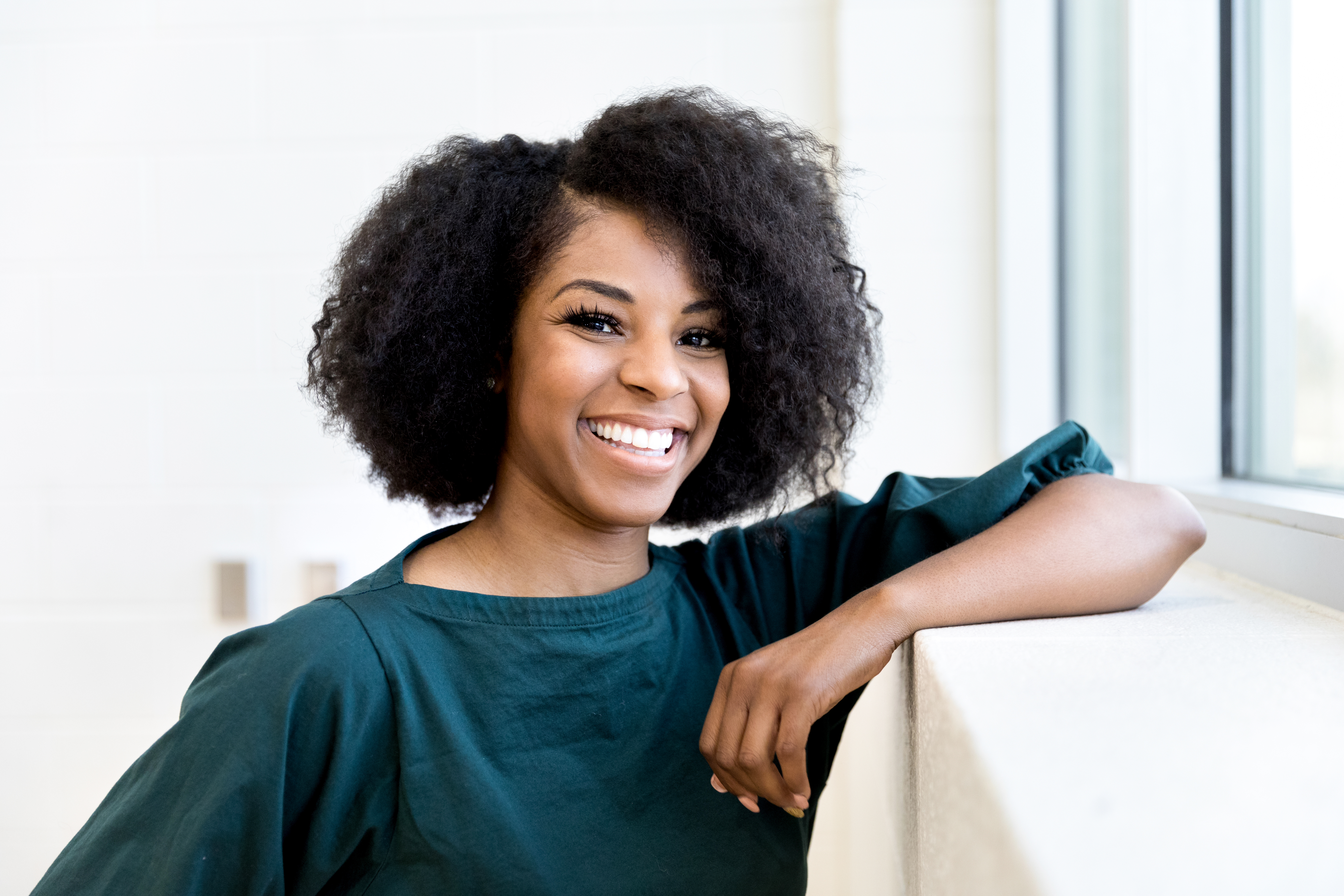 Beautiful university student gives big smile - stock photo