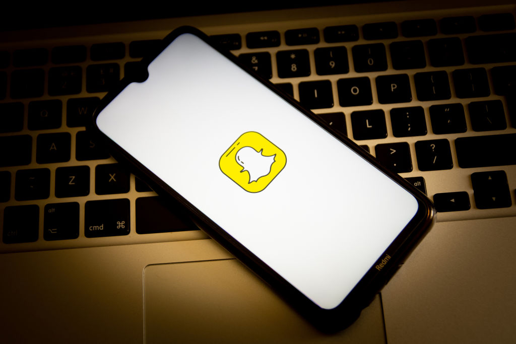 In this photo illustration, a Snapchat logo seen displayed...