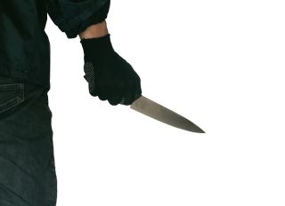 Midsection Of Man Holding Knife Against White Background