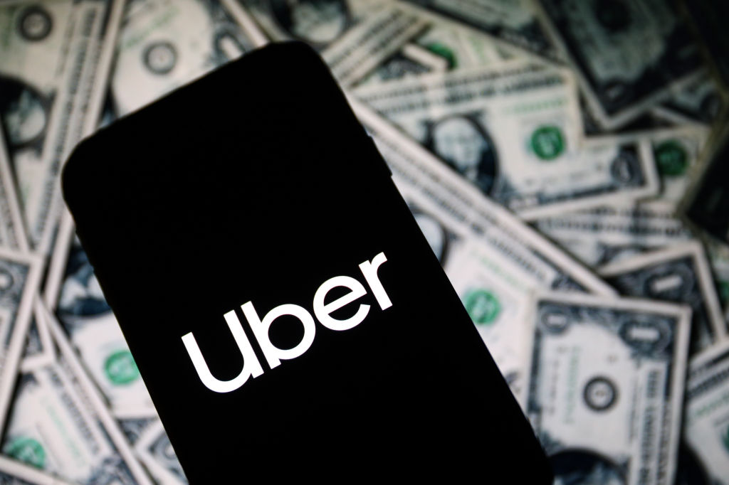In this photo illustration an Uber company app logo seen...