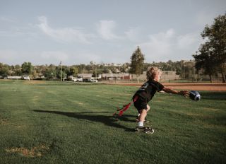 Boy playing flag football catching a ball, California, United States