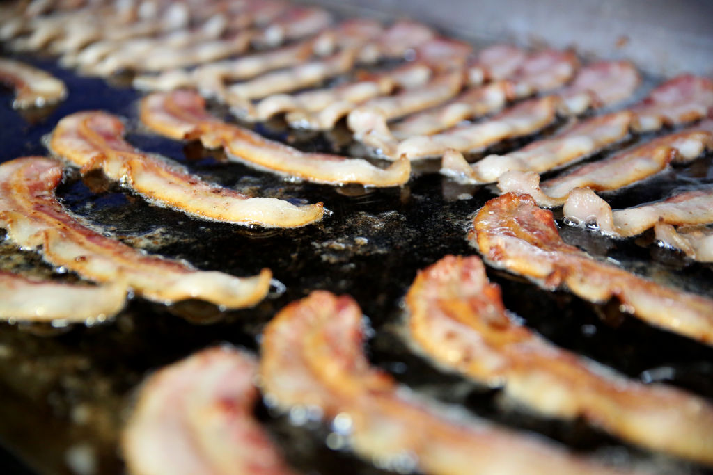 Bacon at the Hatfield Quality Meats stand cooks on the griddle during the Pennsylvania Farm Show on Friday Jan. 16, 2015. Photo by Natalie Kolb 1/16/15