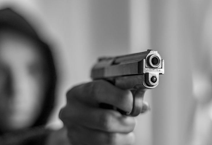Armed woman with hood