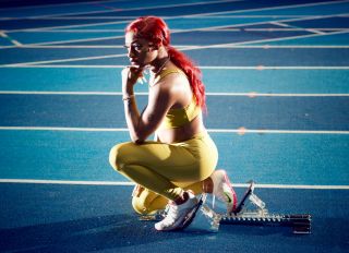 Sha'Carri Richardson Kneels Down On A Track And Field Court