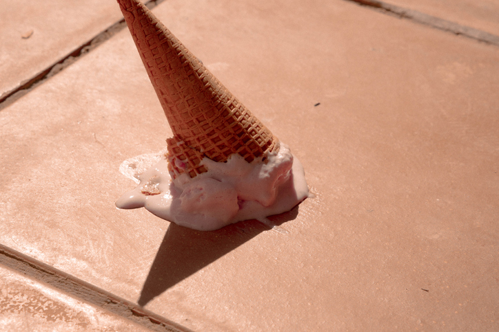 Misfortune picture of ice cream cone fallen in the street floor.