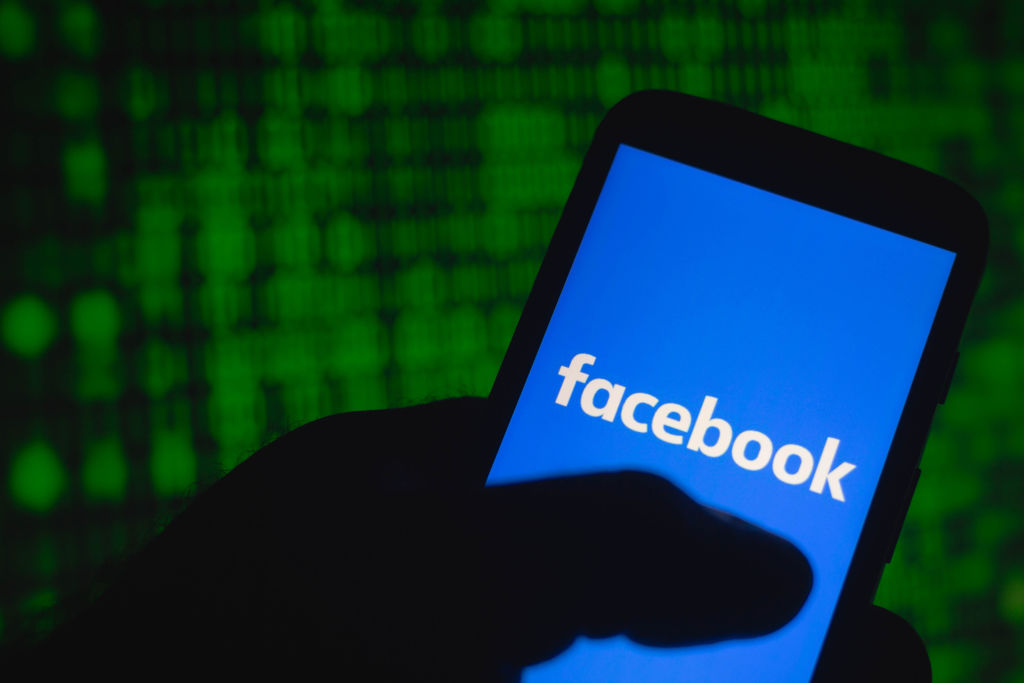 In this photo illustration the Facebook logo seen displayed...