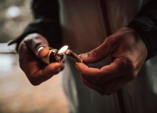 Close-up of man lighting cigarette with lighter