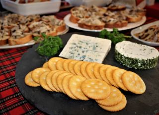 Close-Up Of Buffet Food With Cheese And Biscuits In Foreground