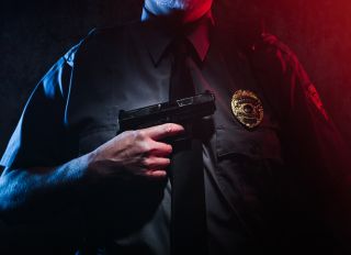 Police Officer Holding Gun