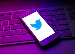 In this photo illustration a Twitter logo seen displayed on...